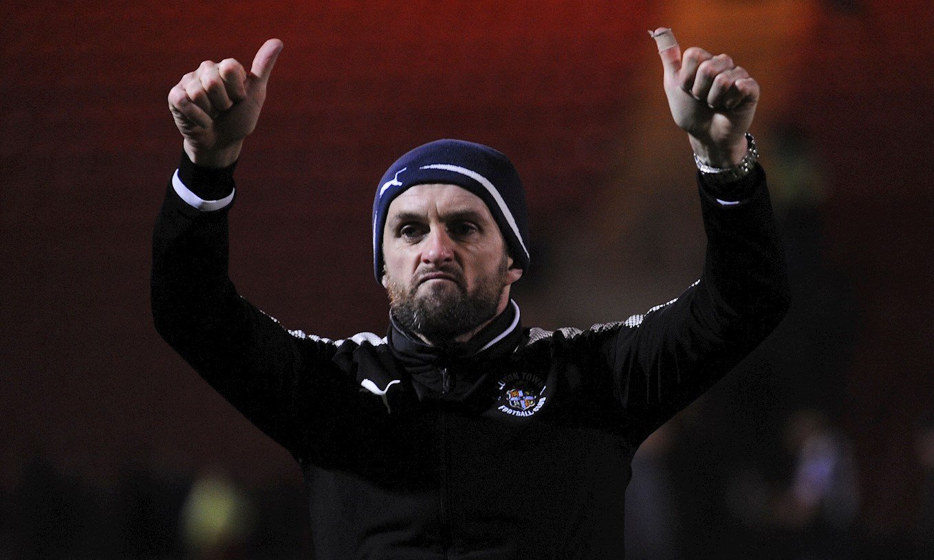 Hatters boss Nathan Jones salutes the crowd after the win at Crewe on November 25th