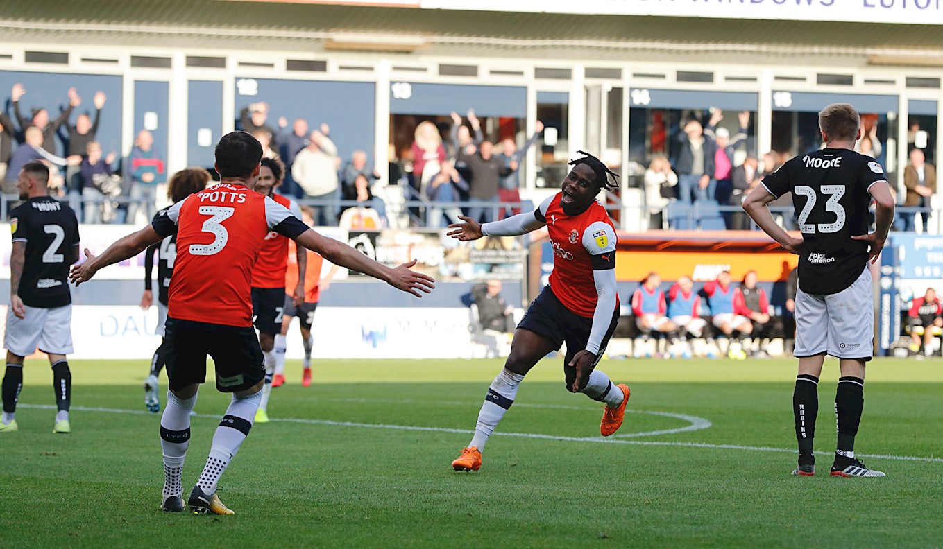 Pelly-Ruddock Mpanzu wheels away in delight after putting the Hatters in front against Bristol City