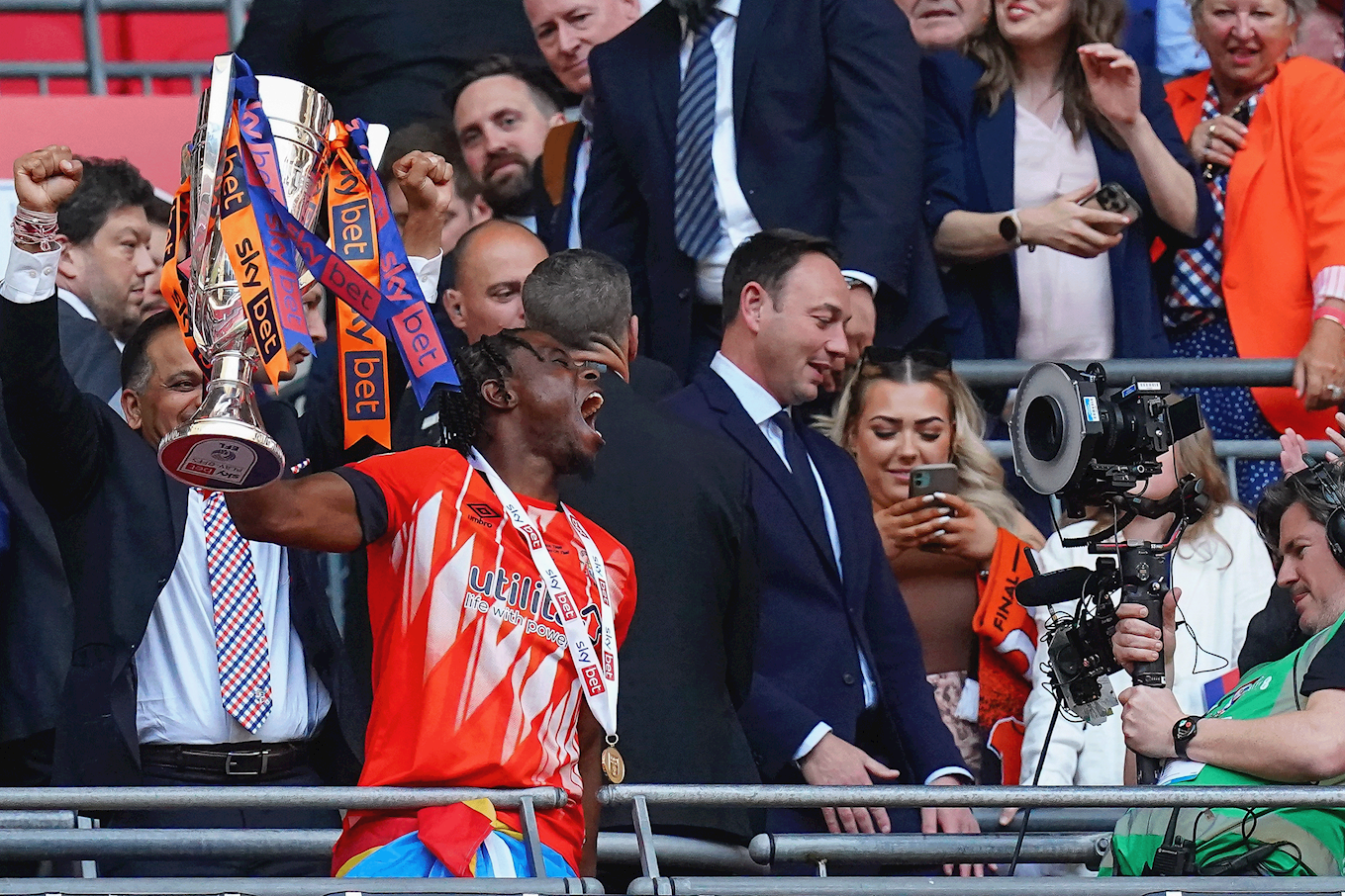 Pelly Ruddock Mpanzu lifting the Championship play-off trophy at Wembley Stadium.