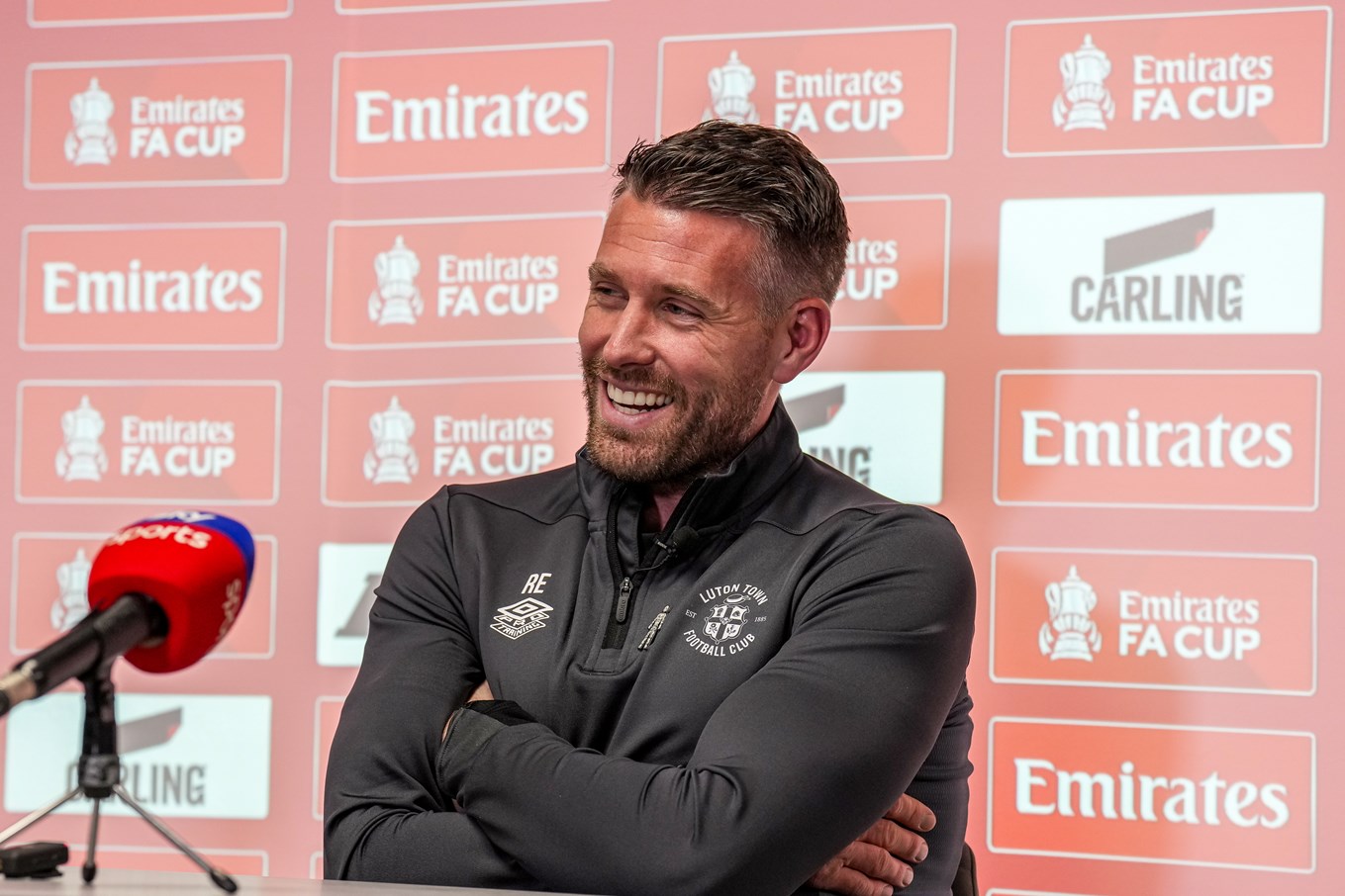 Rob Edwards smiling during his pre-match press conference.