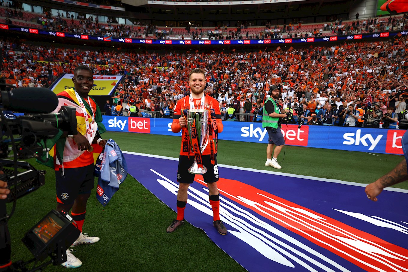 Berry holds the Championship play-off trophy at Wembley in May