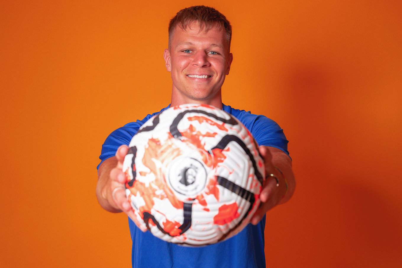 Mads Andersen holding a Premier League football.