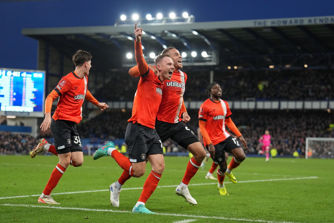 Cauley Woodrow celebrating his winner at Everton with his teammates.