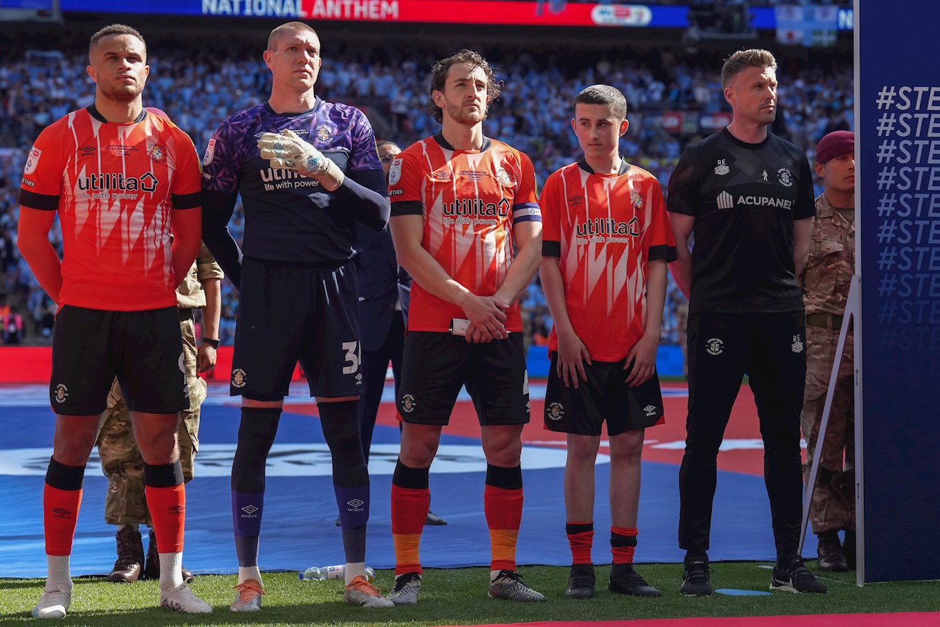 Tom Lockyer lined up with the Luton Town team during the national anthem.