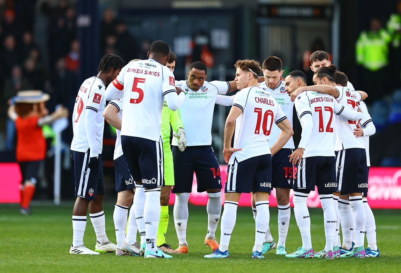 Bolton Wanderers players in a pre-match huddle before our game at Kenilworth Road.