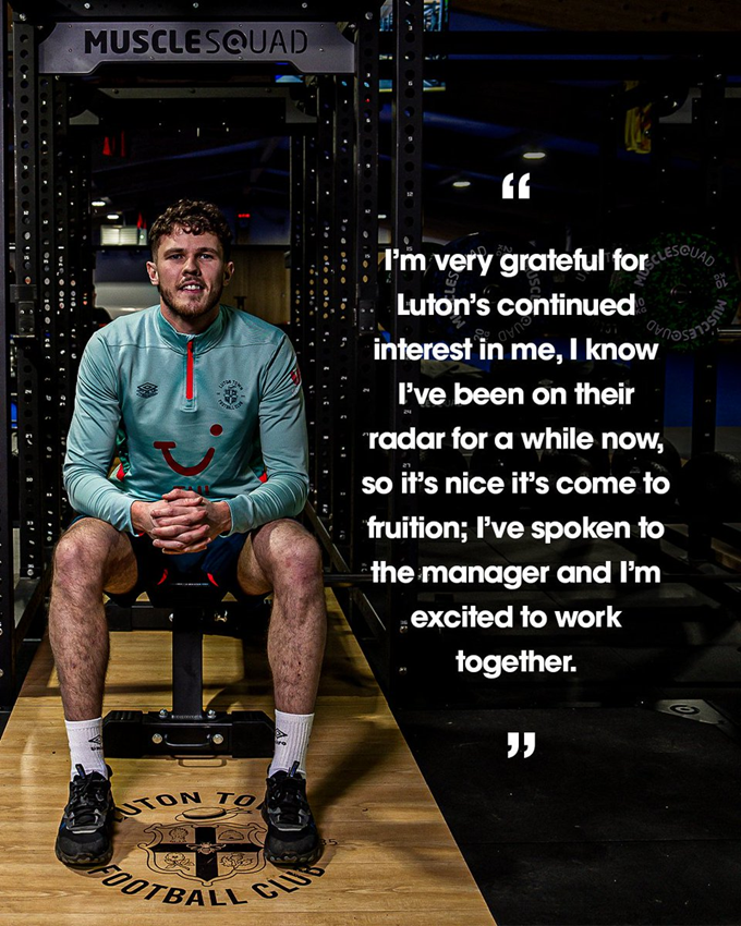 A photo of Tom Holmes in the Luton Town Performance Centre, with a quote that reads "I’m very grateful for Luton’s continued interest in me, I know I’ve been on their radar for a while now, so it’s nice it’s come to fruition; I’ve spoken to the manager and I’m excited to work together."