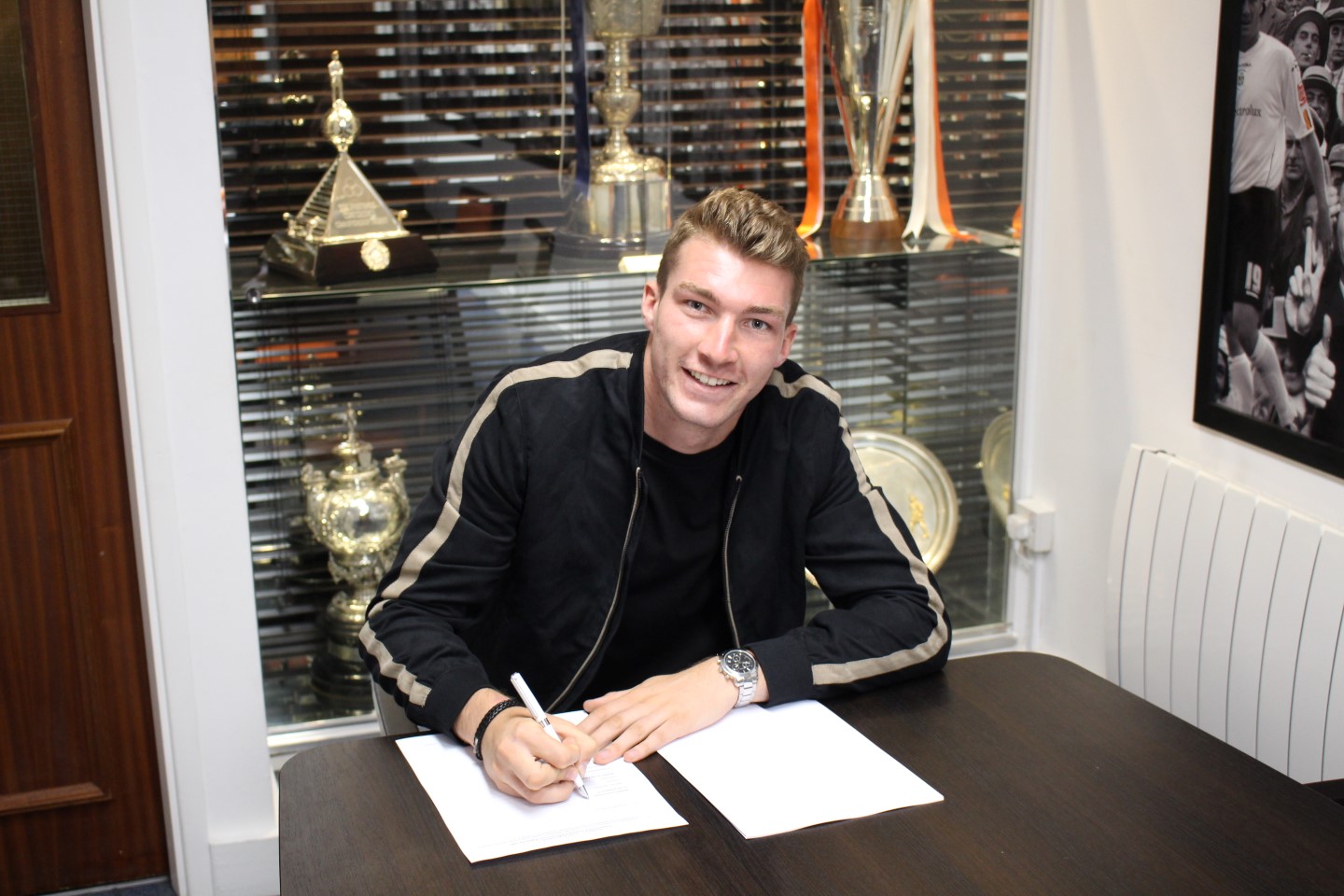 Jack Stacey signs his contract with the Hatters in the Kenilworth Road Trophy Room
