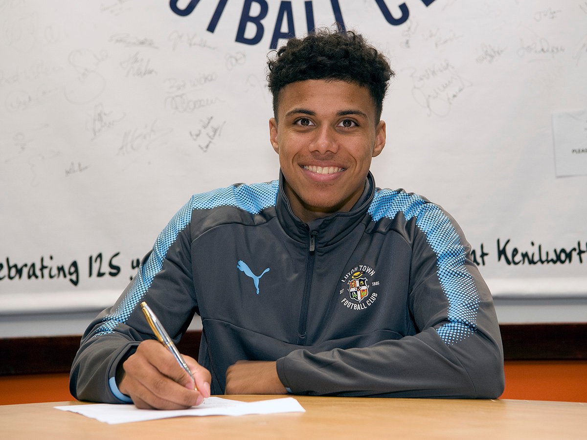 James Justin is pictured signing his new contract a fortnight ago