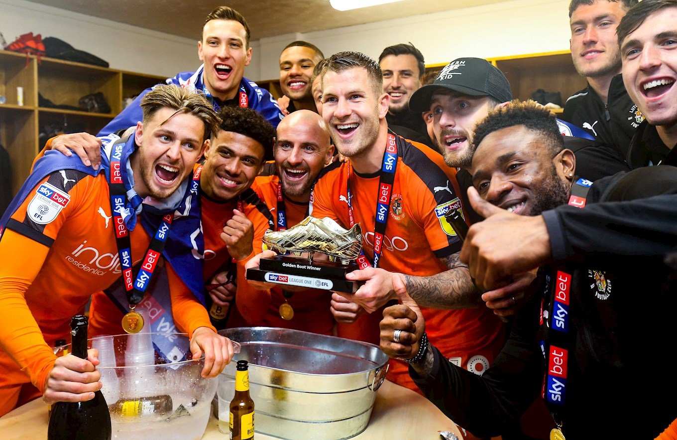 James Collins with his League One golden boot award celebrating the 2018-19 title with his Hatters team-mates
