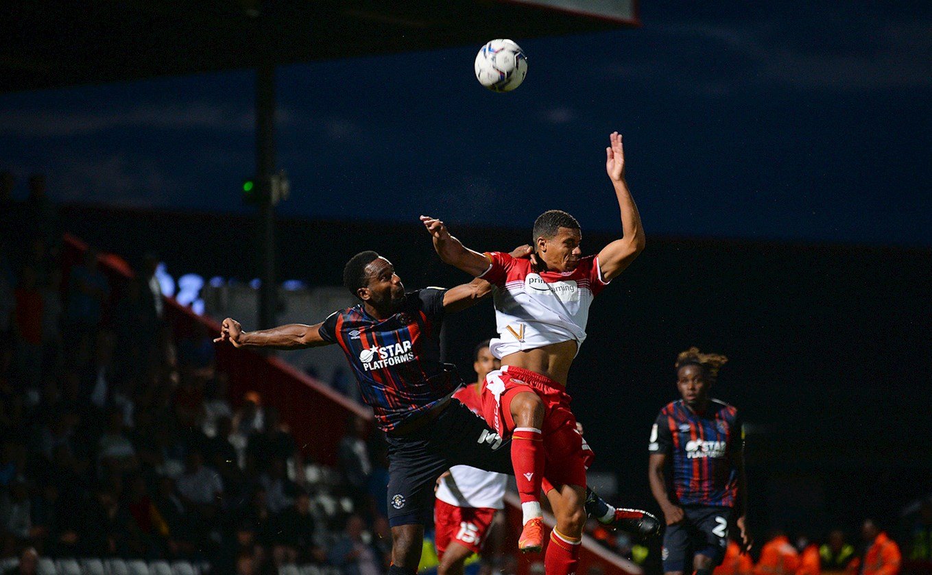 Hatters striker Cameron Jerome competes for a high ball with Stevenage defender Terence Vancooten