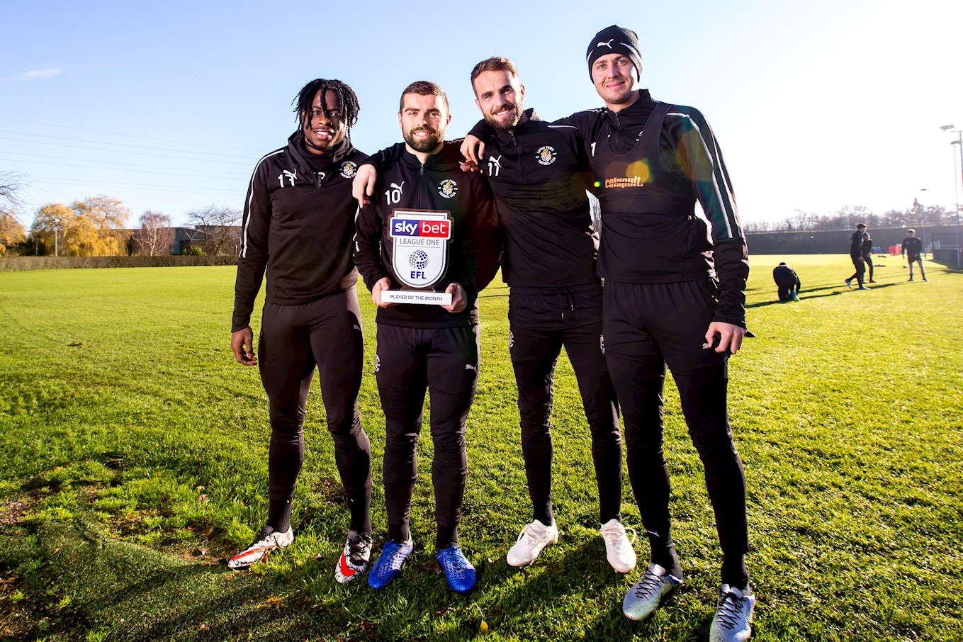 Hatters forward Elliot Lee is congratulated on his Sky Bet League One player of the month award for November by team-mates Pelly-Ruddock Mpanzu, Andrew Shinnie and Harry Cornick