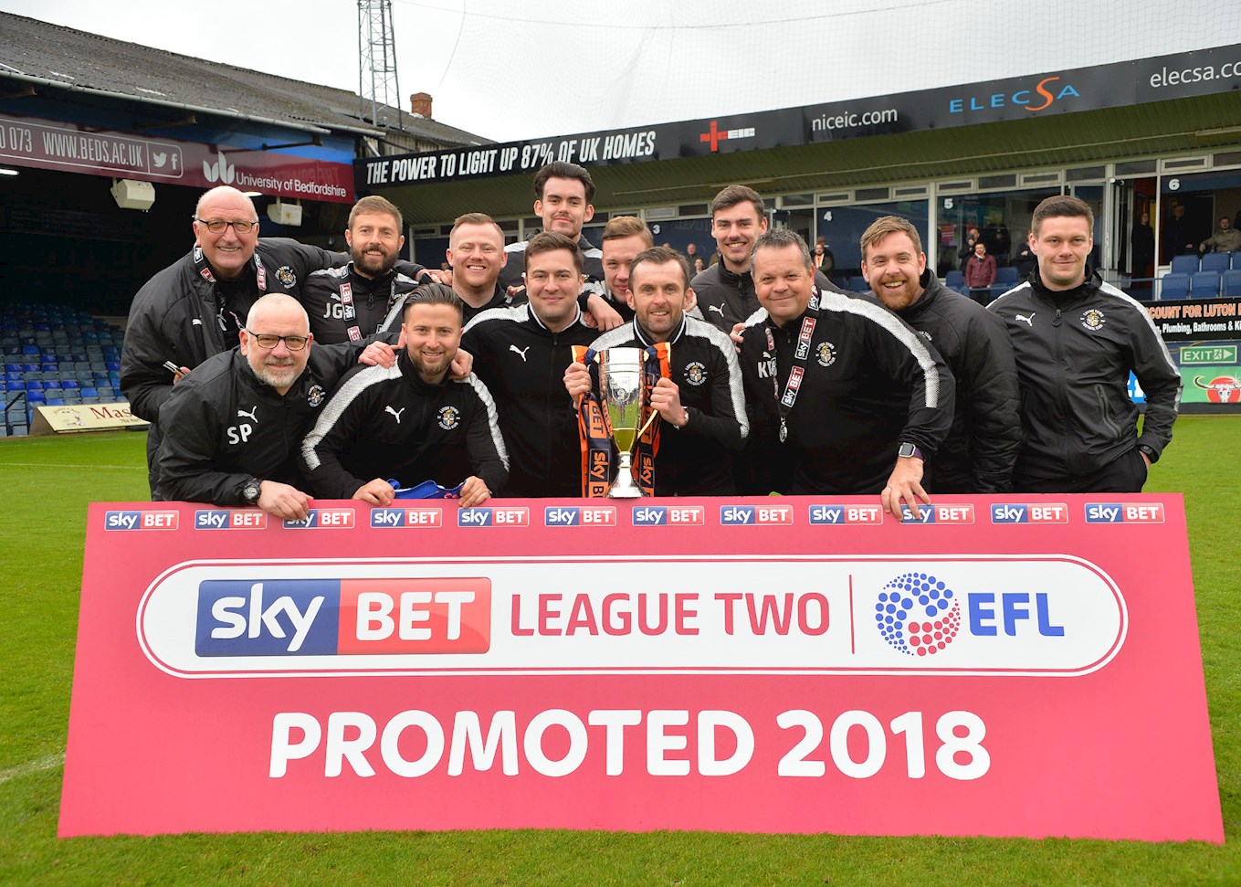 Paul Hart, far left, celebrates the first promotion of his 48-year career in senior football with the Hatters staff at the end of last season