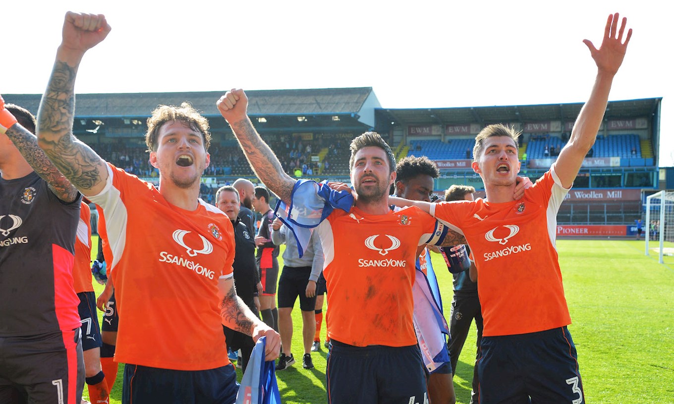 Alan Sheehan celebrates promotion from League Two on the pitch at Carlisle with Glen Rea and Dan Potts