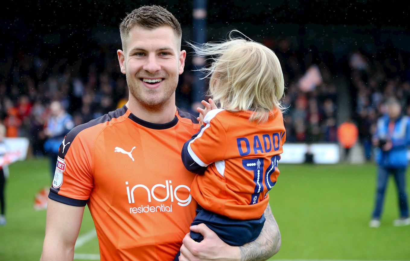 James Collins carries his son Cooper out onto the Kenilworth Road pitch before the final home game of the season against Forest Green in 2017-18