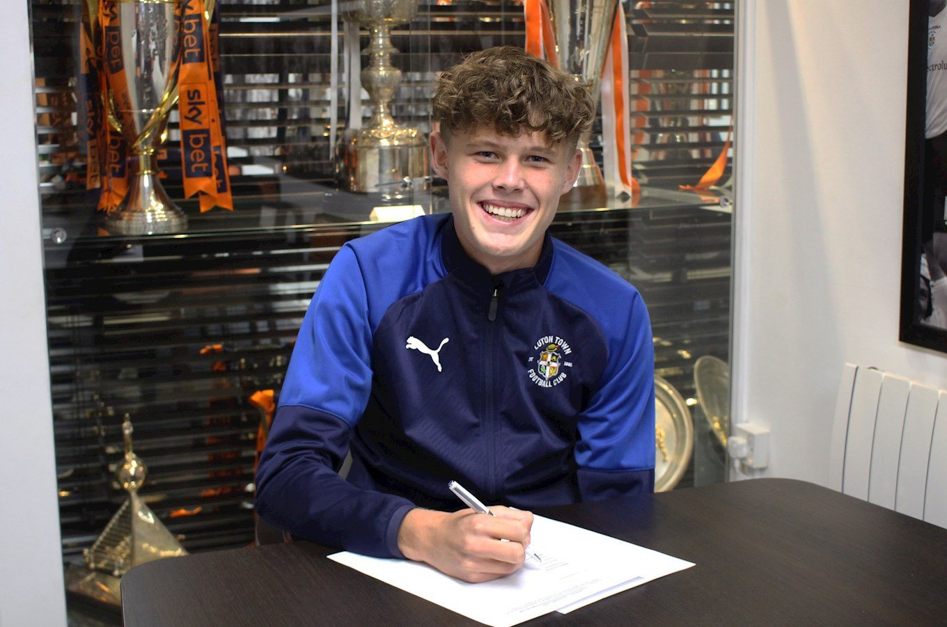 Having turned 17 in October, Sam puts pen to paper on his first professional contract