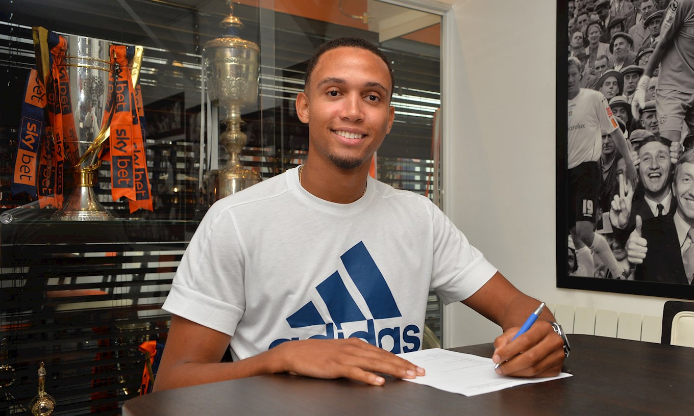 Brendan Galloway signs his Luton Town contract in the Trophy Room at Kenilworth Road