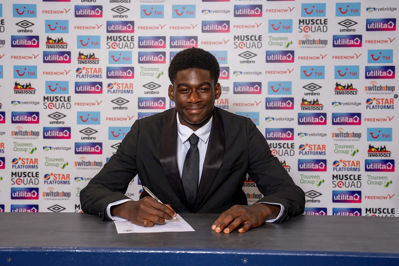 Jamie Odegah signing his contract.