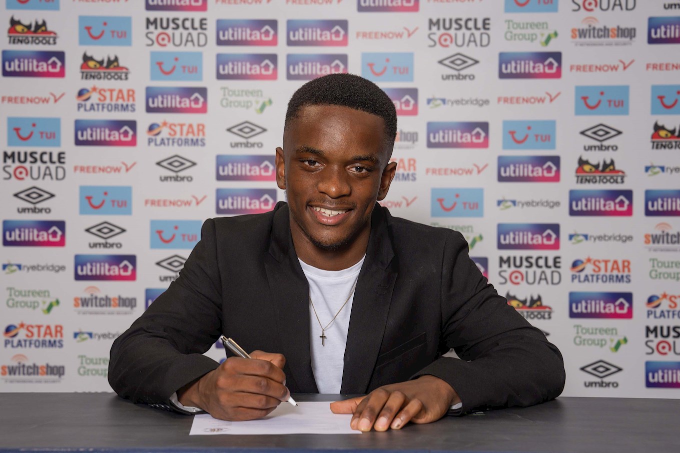Matthew Takawira signing his contract.