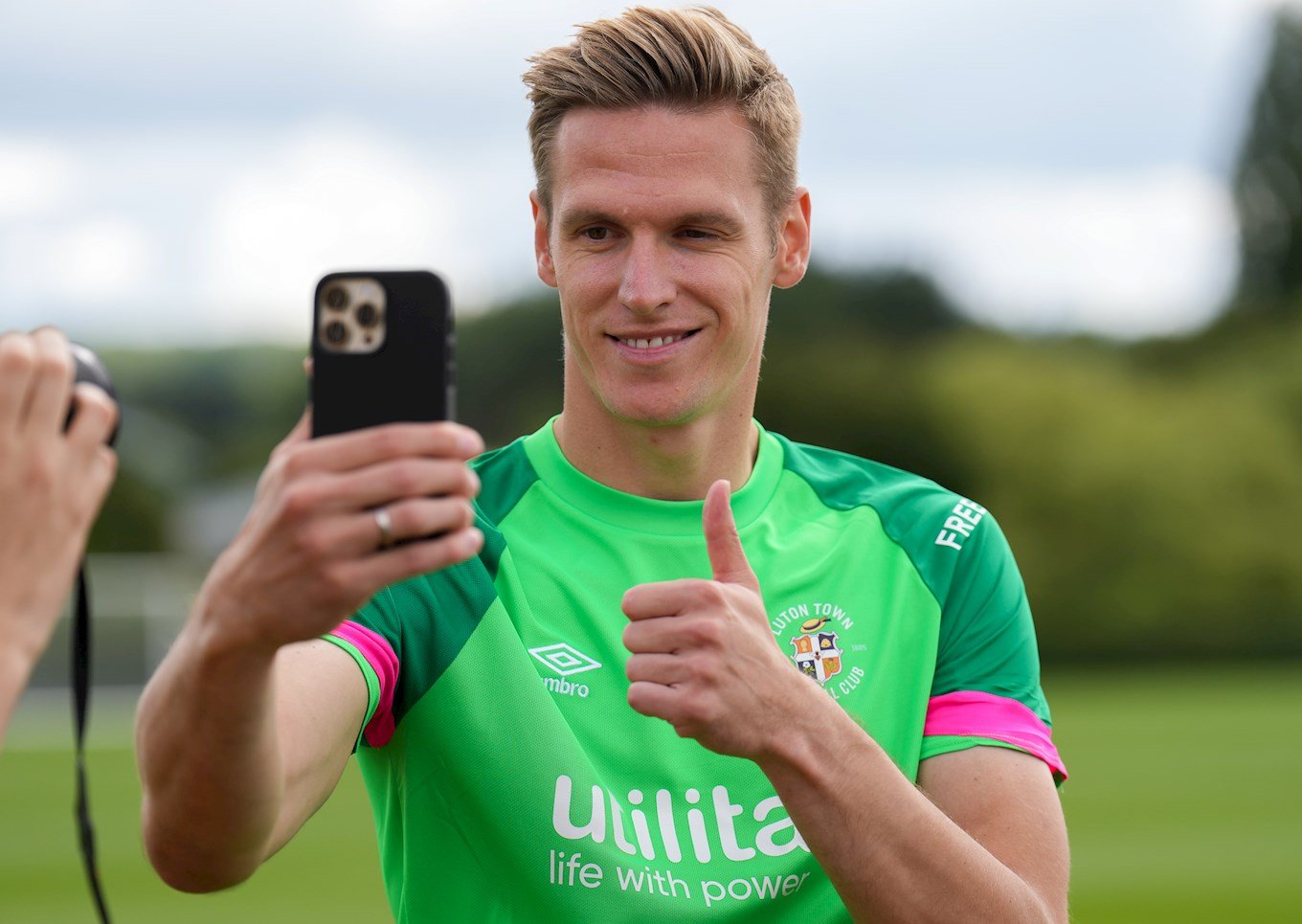 Thomas Kaminski recording a video message to Luton Town fans through a phone.