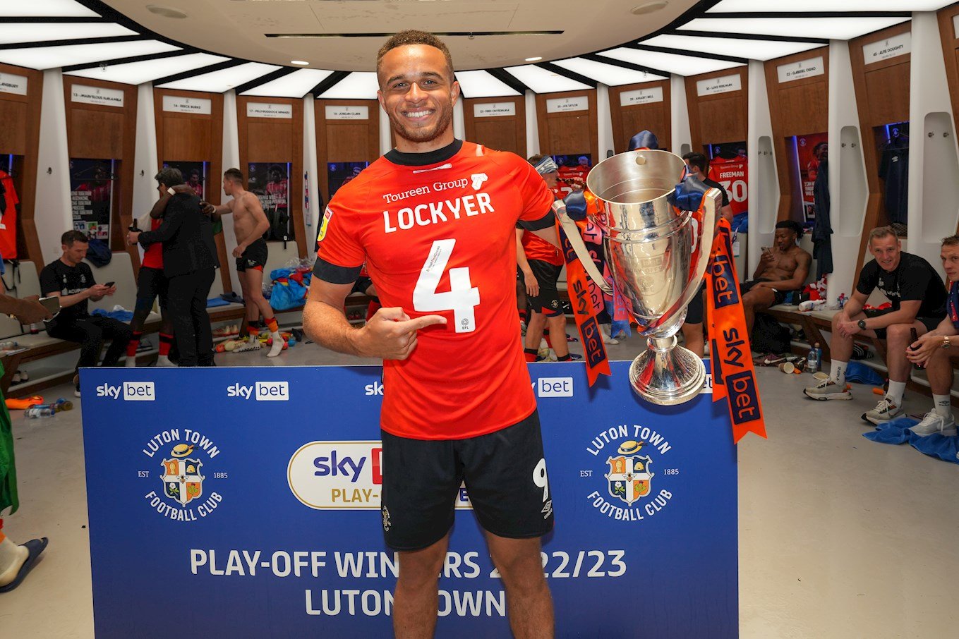 Carlton Morris with the play-off final trophy in the dressing room at Wembley