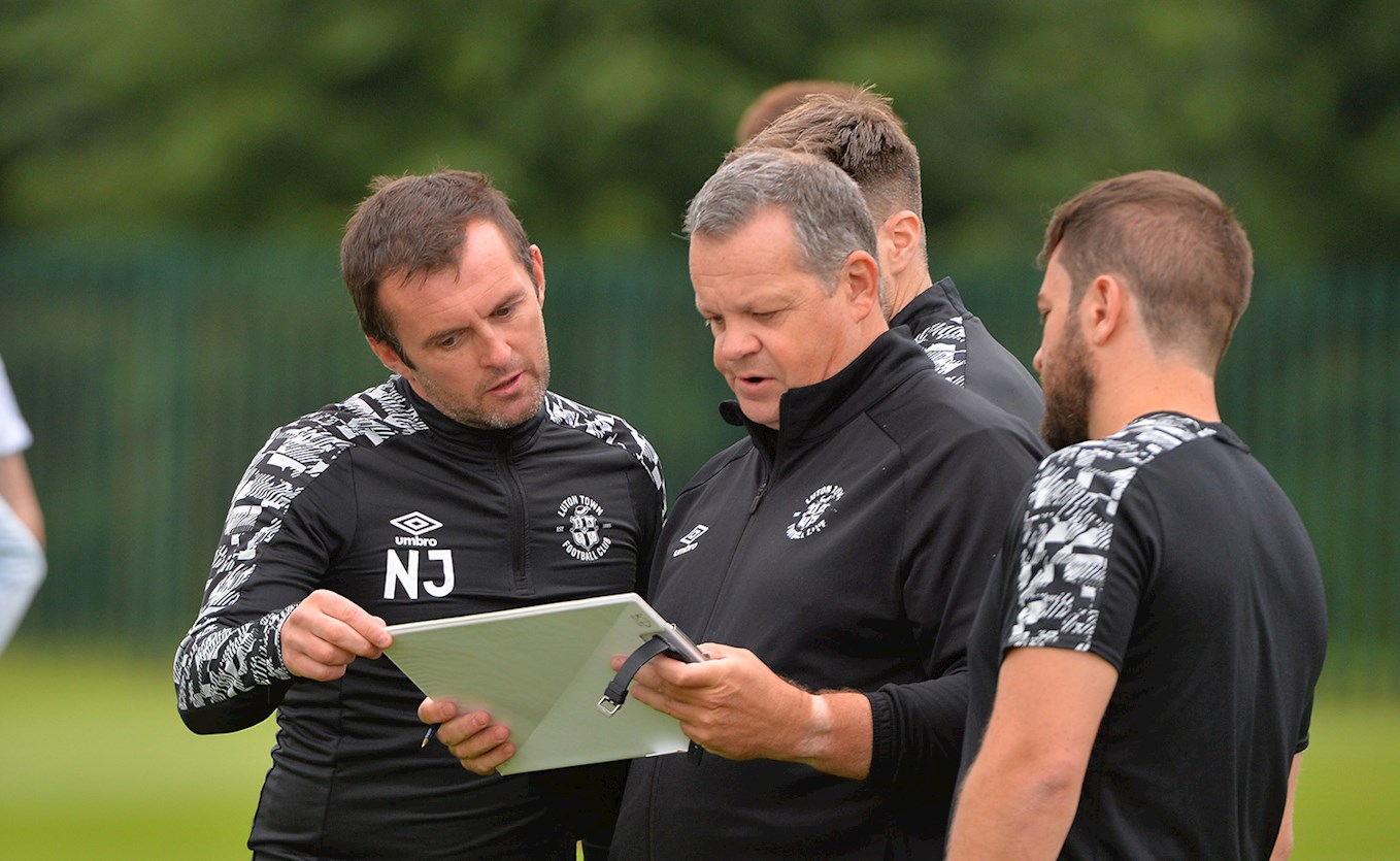Manager Nathan Jones and some of his backroom staff at training 